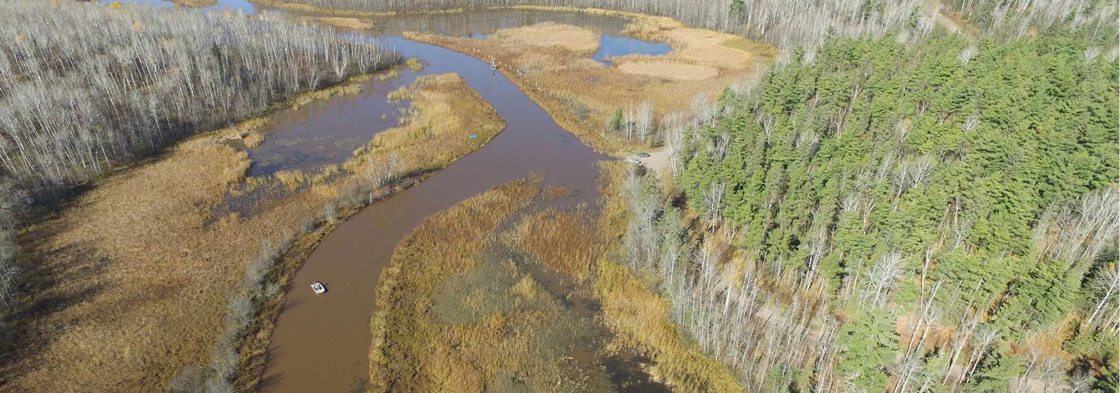 An aerial image of a river winding through a marshy area.