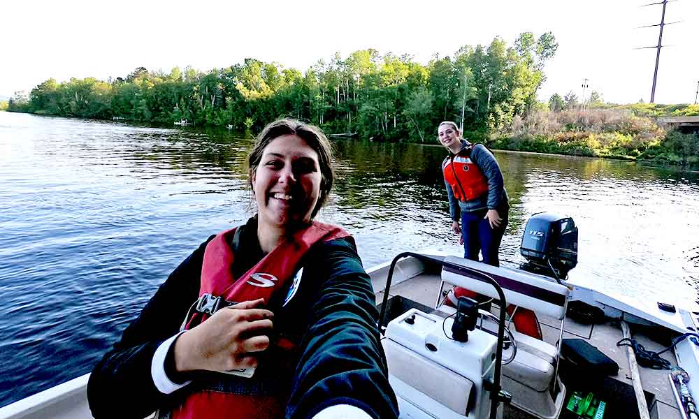 Two young women in a boat on a river