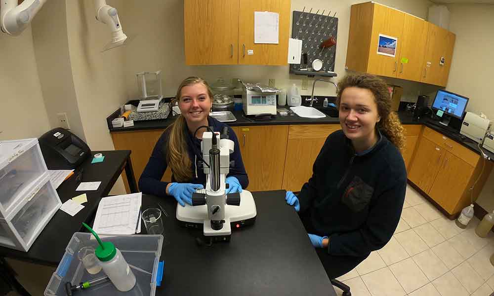 Two young women working in a lab