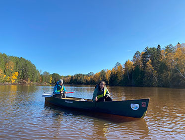 Two girls in a canoe on a river